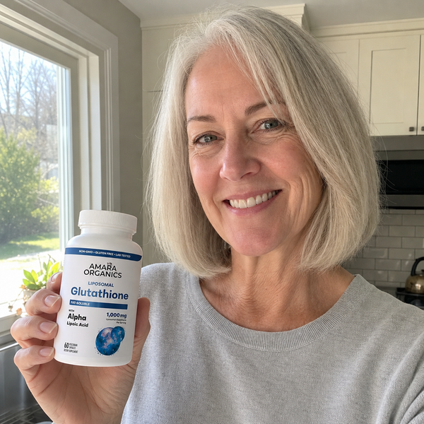 Woman in her 50s with bright-looking skin holding Amara Organics Liposomal Glutathione